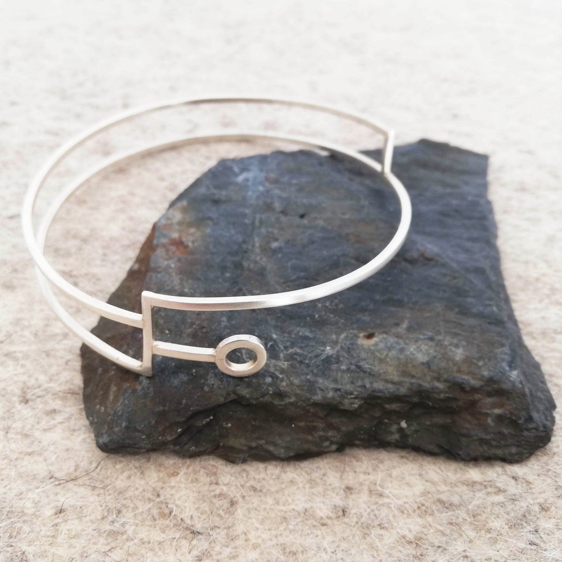 Silver linear bangle with circle detail by Inplico Design. Linear Bangle 1 made by Roz Adams