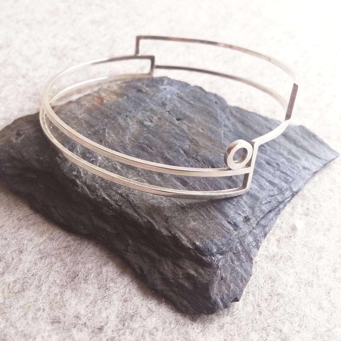 Silver linear stepped bangle with circle detail side view by Inplico Design. Linear Bangle 2 handmade by Roz Adams
