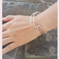 Silver linear stepped bangle with circle detail worn on wrist. Linear Bangle 2 part of Inplico Design and handmade by Roz Adams